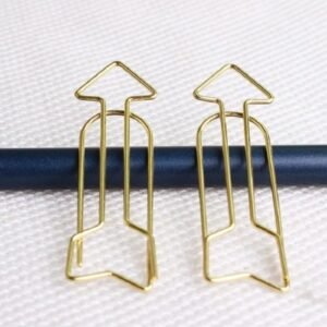 Arrow Shaped Golden Metal Paperclip In A Box